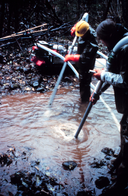 A close-up of air being pumped into the floor of the riverbed to loosensediments