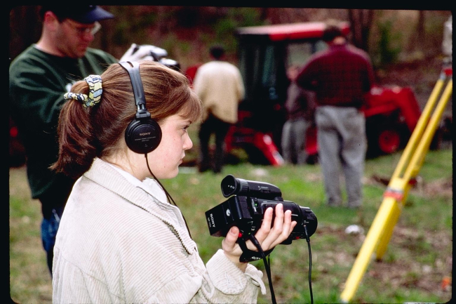 A local middle school student videotapes the soil testing procedures atthe future dam removal site as part of a documentary the school is producing