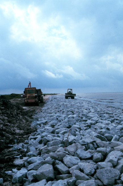 A view of the rock-armored beach with construction equipment