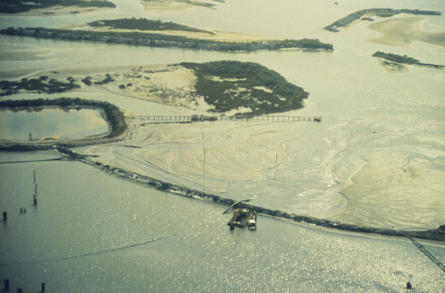 East Timbalier Island, booms are placed to contain oil