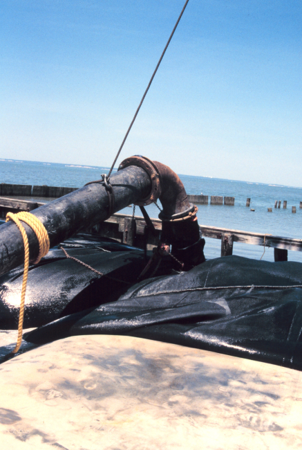 A dredge pipe filling a geotube