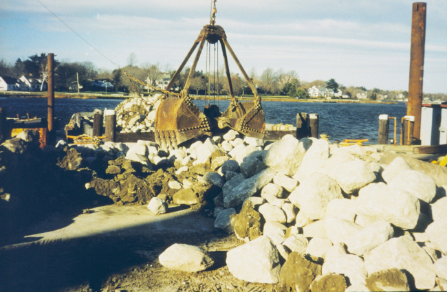 Loading reef construction materials onto barges for transportation to the reefsites