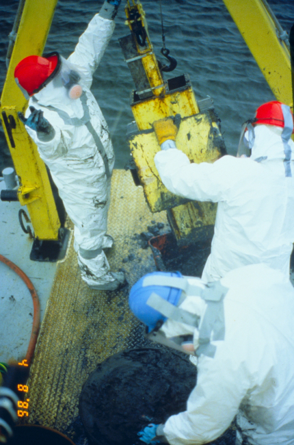 Workers dressed in full hazmat gear conduct research to determine the levelof contaminants or PCB levels