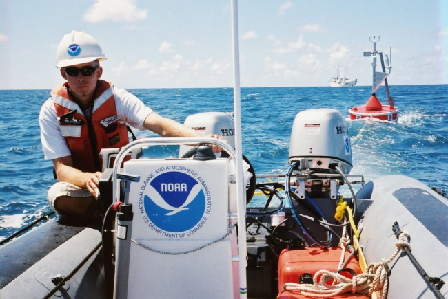 A CREWS buoy is towed from NOAA ship TOWNSEND CROMWELL for deployment inshallow water