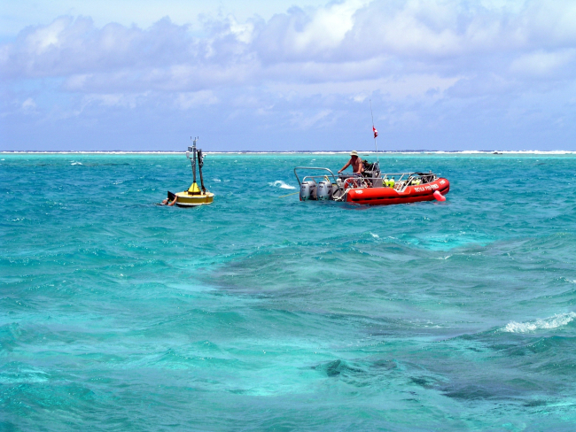 Oceanographers deploy a CREWS buoy inside an atoll
