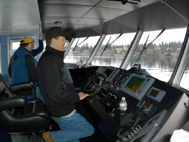 Captain Chuck Curry at the helm of the R/V MANTA during shakedownoperations near Bellingham, Washington