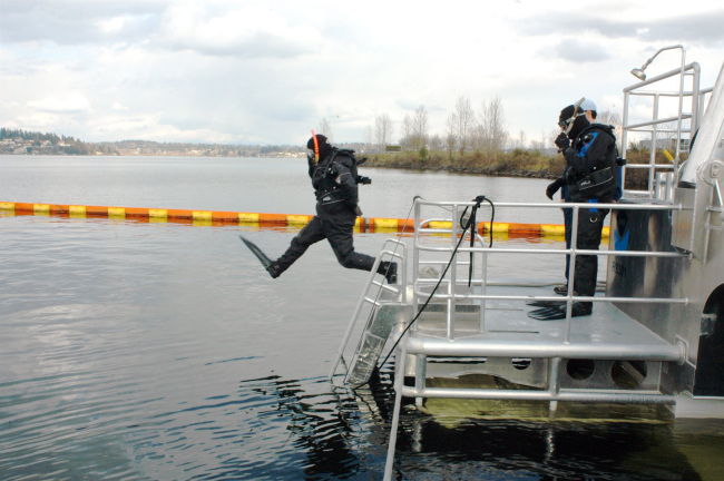 National Marine Sanctuary Director Dan Basta takes the first leap from thediving platform of the R/V MANTA in Lake Washington