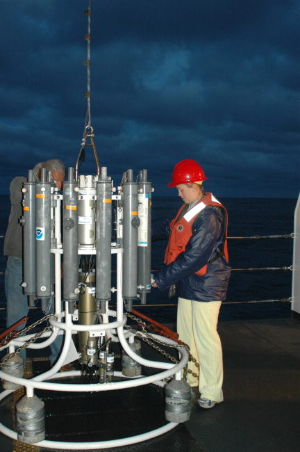 Oceanographer Liz Zele prepares to deploy the CTD from the deckof the NOAA Ship McARTHUR II with the help of technician Lacey O'Neal