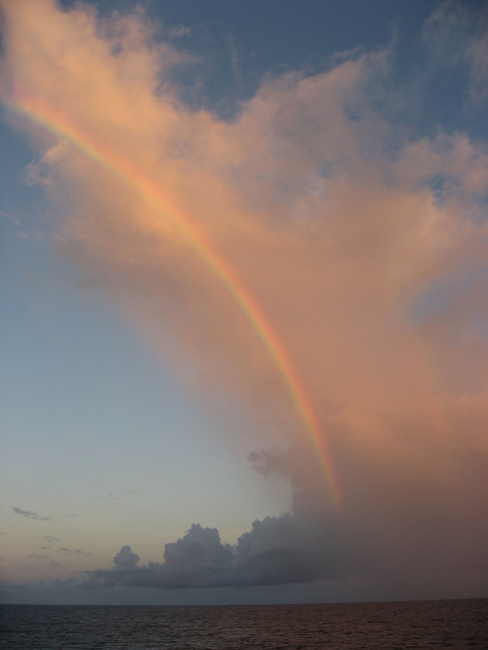 A spectacular late afternoon rainbow following the arc of a cloudformation