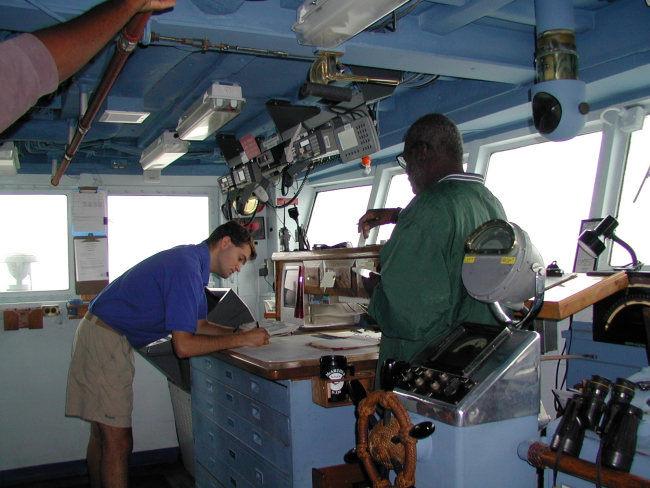 NOAA Corps Ensign Doug Krause and Seaman Surveyor Leroy Johnson onbridge wing of NOAA Ship McARTHUR