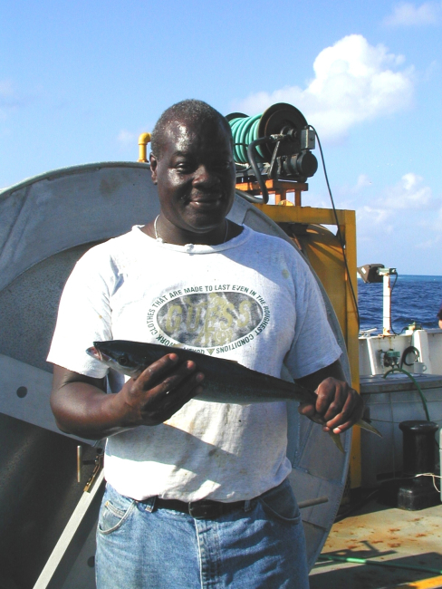 Seaman surveyor Leroy Johnson holding rainbow runner caught offClipperton Island