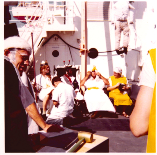 A properly respectful pollywog bowing before King Neptune during Equatorcrossing ceremonies on the ESSA Ship DISCOVERER
