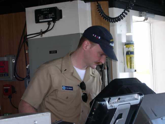 Ensign Salisbury on watch checking the radar