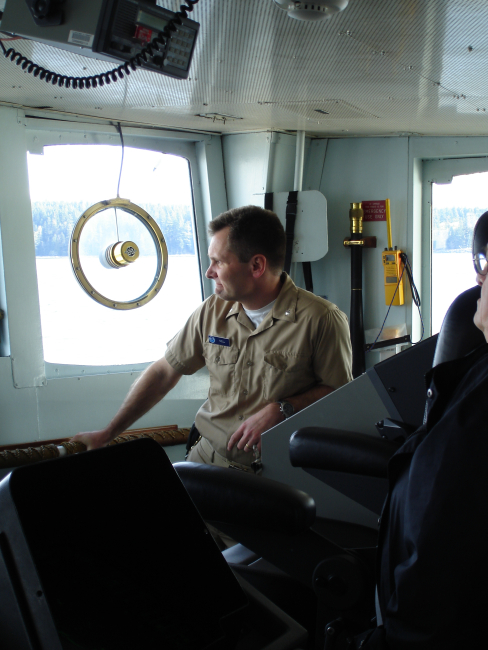 Commander Guy Noll, commanding officer of the NOAA Ship RAINIER,maintaining watch as the RAINIER traverses constrained waters in Alaska