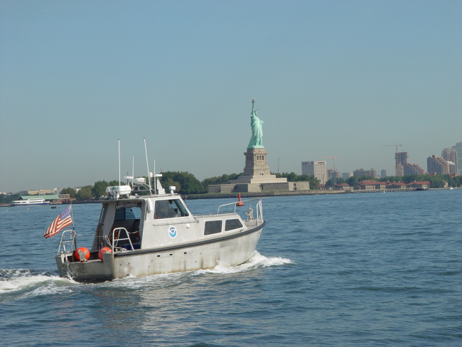 Survey launch off the NOAA Ship THOMAS JEFFERSON conductinghydrographic survey in New York Harbor near the Statue ofLiberty