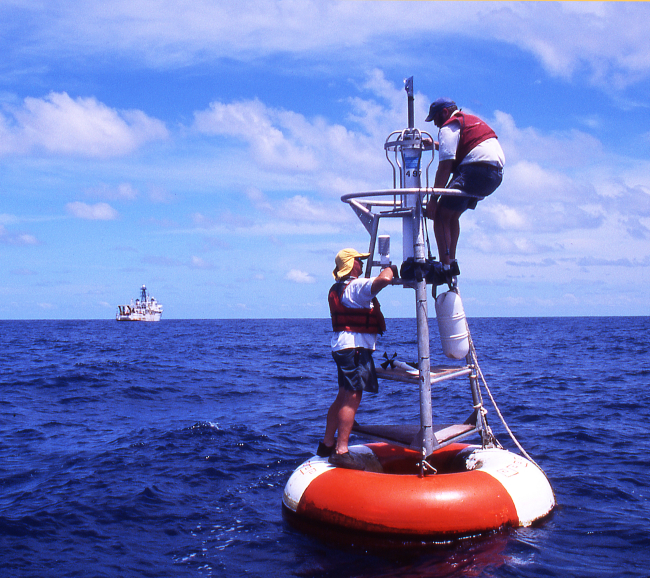 BGL Jim Donovan (L) and TAO Mooring specialist Brian Powers (R)repair a TAO mooring while NOAA Ship KA'IMIMOANA stands by