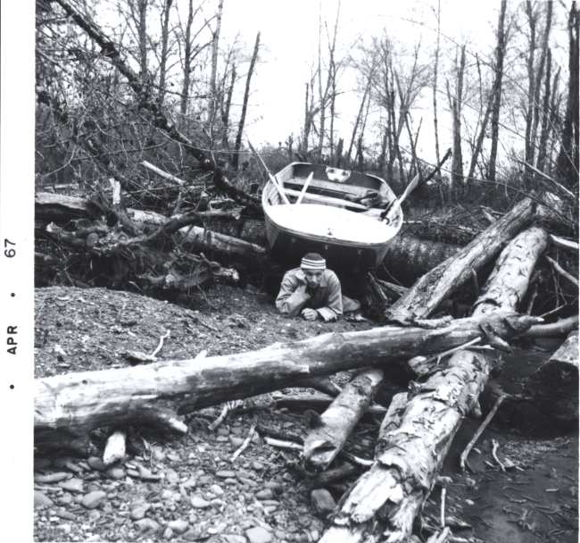 Fisheries researchers dragging boat over log jam on Pacific Northwest salmonstream