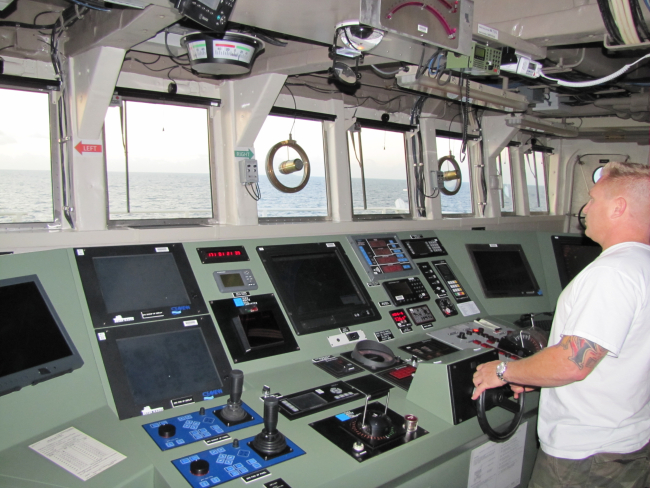 Helmsman steering the NOAA Ship PISCES on course directed by the officer of thedeck