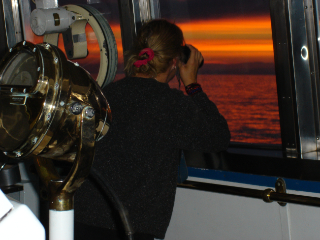 Lookout on watch at sunset on NOAA Ship MILLER FREEMAN