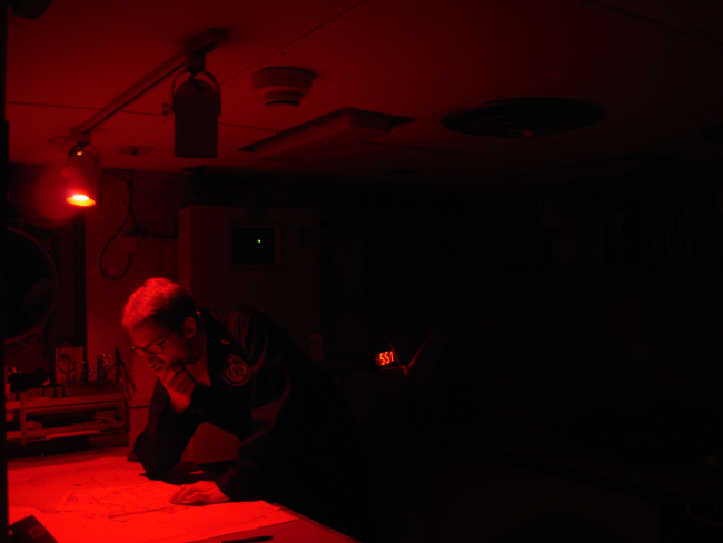 Chart work at night in chart room of the NOAA Ship MILLER FREEMAN