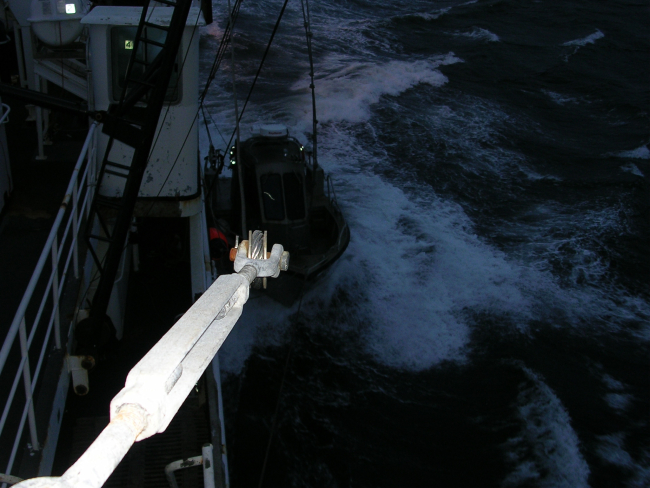 Picking up small boat while underway in moderate seas offshore Kodiak