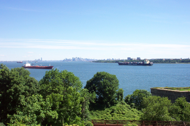 The containership SEALAND COMMITMENT entering New York Harbor with the New Yorkskyline in the distance