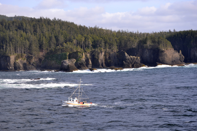 A small fishing boat takes a short-cut between Tatoosh Island and CapeFlattery