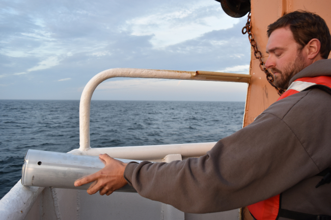 Chris Tremblay, from NEFSC, deploying a sonobuoy to listen for sei whales offthe stern of the NOAA SHIP GORDON GUNTER