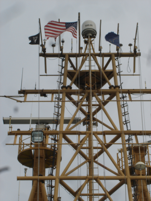 Mast of NOAA Ship OSCAR DYSON flying American flag andAlaska State flag