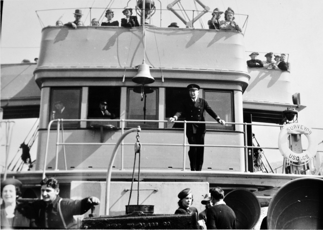 Commanding officer Captain Ray Schoppe on the bridge of theSURVEYOR as it serves as a courtesy vessel for dignitaries at the launching ofthe Coast and Geodetic Survey Ship EXPLORER