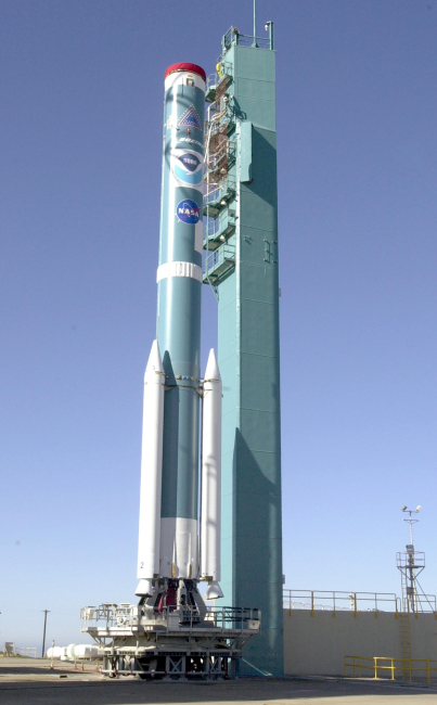 The first stage of a Boeing Delta II rocket rests on the launching pad