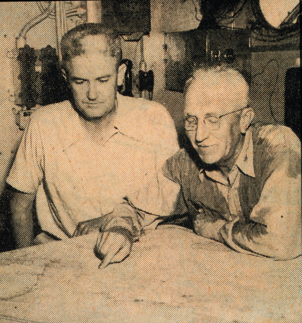 Captains George Anderson and Fred Peacock reviewing survey work onthe Coast and Geodetic Survey Ship HYDROGRAPHER while operating in  theGulf of Mexico