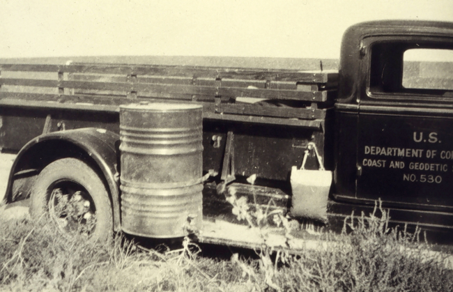 Bench mark truck showing mounting of water barrel
