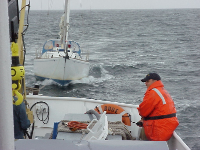 NOAA Ship RUDE towing a disabled sailboat into a safe harbor