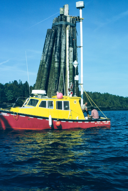 Canadian Hydrographic Service launch checking NOAA tide gauge duringinternational cooperative charting project on Passamaquoddy Bay