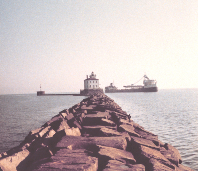 Fairport Harbor breakwater with Great Lakes ore carrier entering the harbor