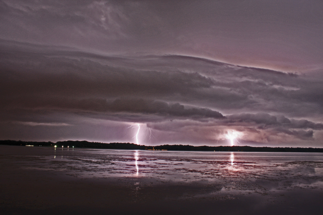 Lightning in the distance seen over bay waters