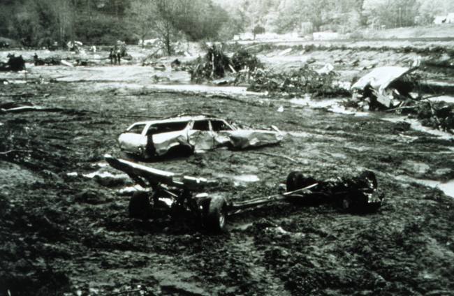 Twisted remains of a vehicle and other debris following a flash flood