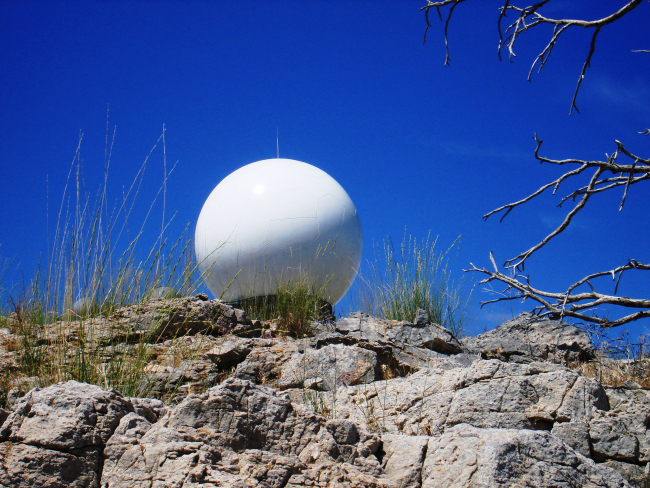 Is it a giant soccer ball? No, this is the Salt Lake City radar dome seen from a vantage point below a rock outcrop