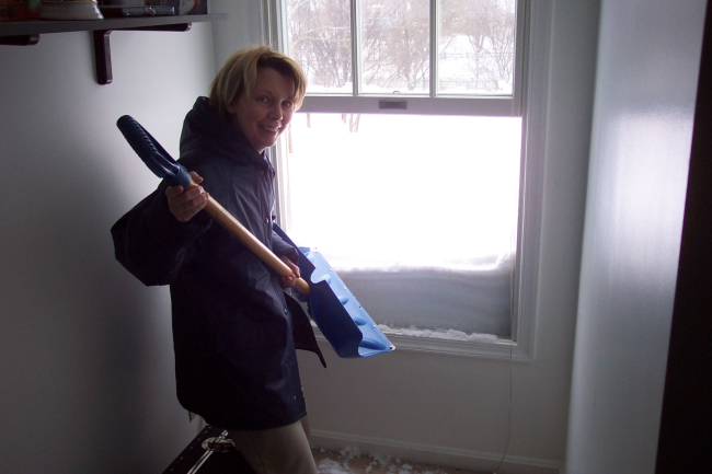 Shoveling off the roof from a second floor bedroom window