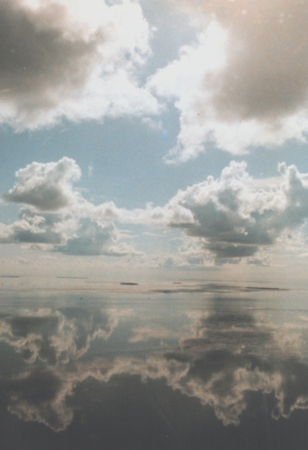 Which way is up?  A mirror-smooth sea reflects cumulus clouds on a still morning in the Keys