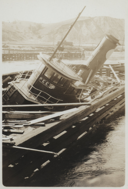 The tug GASPEE sitting on the bottom over a what appears to be the remains ofa destroyed pier