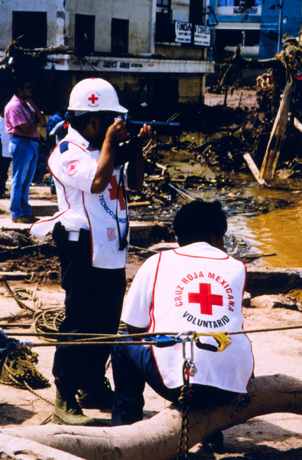 Red Cross worker documenting the damage caused byHurricane Mitch