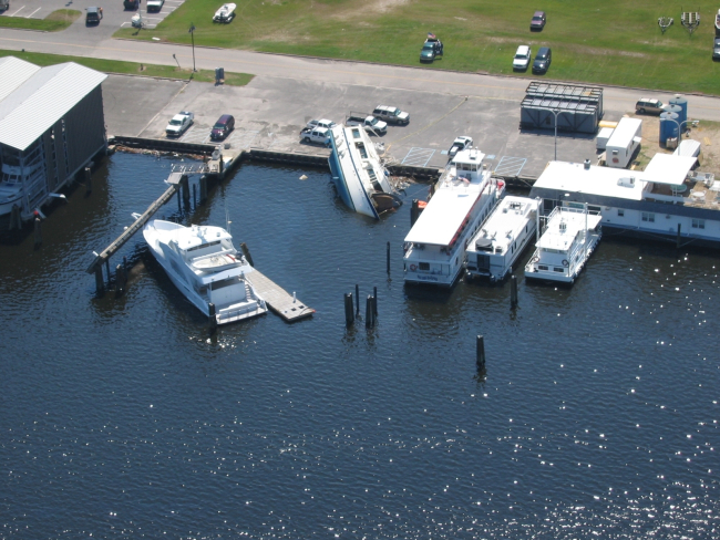 A curious effect of Hurricane Katrina left one boat on the pier while othersappear to have escaped relatively unscathed