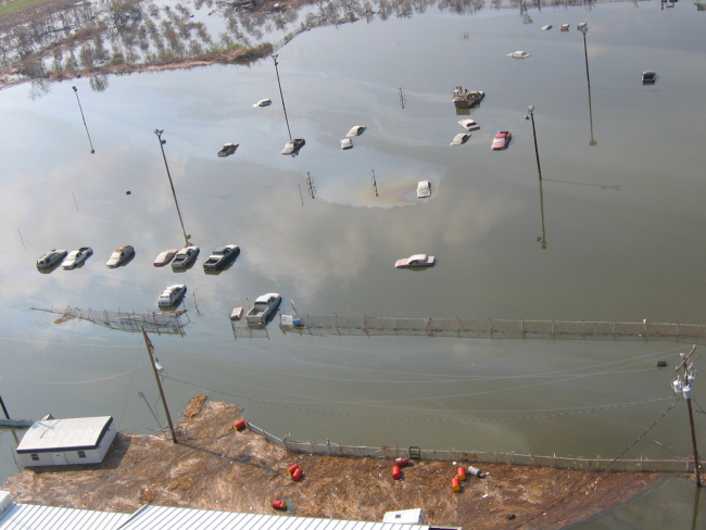 Not boats but cars in a parking lot turned pond making their own oil slicks