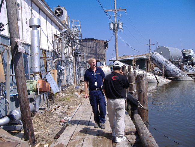 Wayne Weikel inspecting damage to fisheries infrastructure following Hurricane Katrina