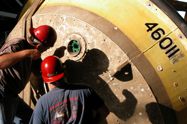 Technicians preparing 3-Meter Buoy for sub-surface instrumentation