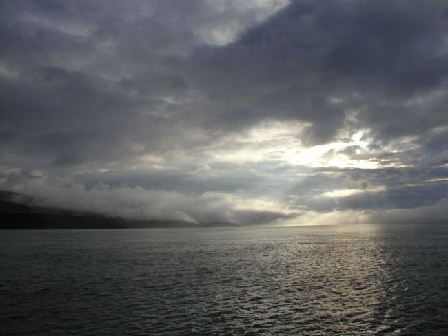 An array of clouds, fog, and sunshine on the Alaska Peninsula