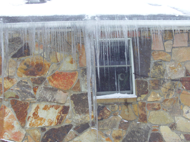King-size icicle on home of Coroner Kelley during meltdown following back-to-back major storms a week earlier