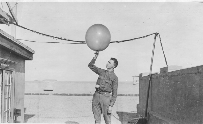 Signal Corps meteorological student Greening launching a weather balloon